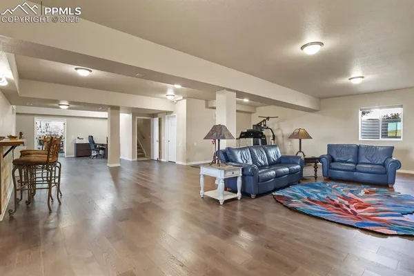 a living room with furniture and wooden floor