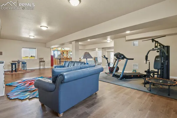 a living room with furniture and gym equipment