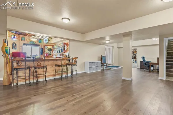 a view of a living room or kitchen and a wooden floor