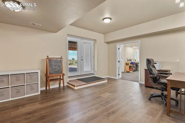 a view of a workspace with furniture and a workspace