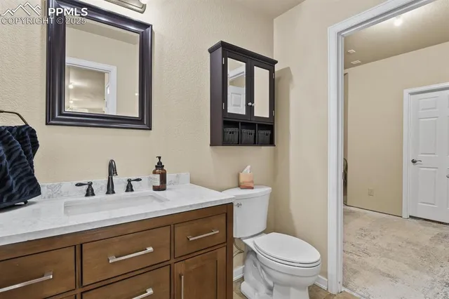 a bathroom with a toilet a sink and mirror