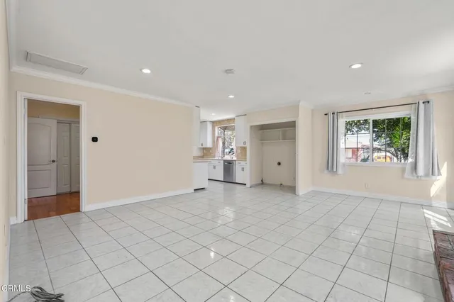 an empty room with windows and entrance