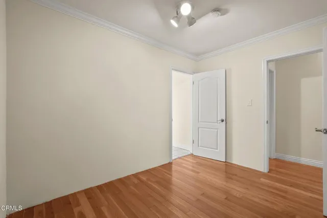 a view of an empty room with wooden floor
