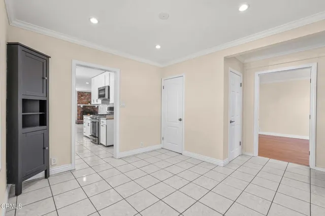 a view of a kitchen with furniture and an empty room