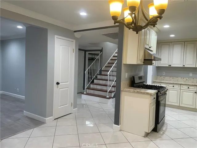 a kitchen with a stove cabinets and a stove top oven