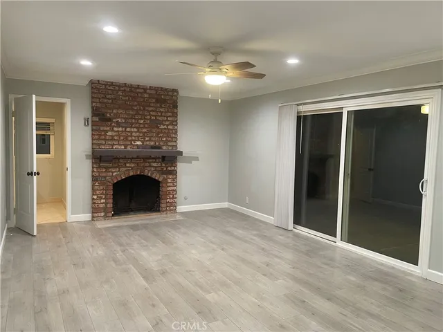 a view of an empty room with a fireplace