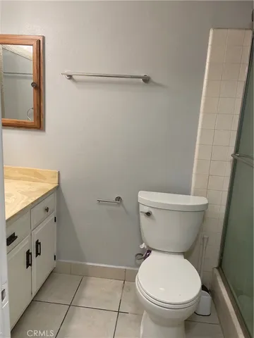 a white toilet sitting next to a bathroom sink