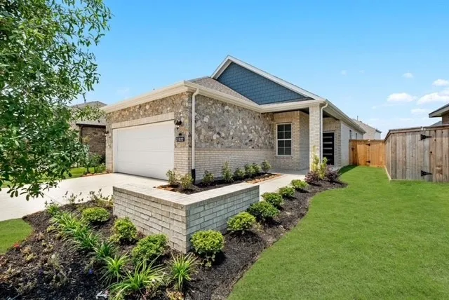 a front view of house with a garden