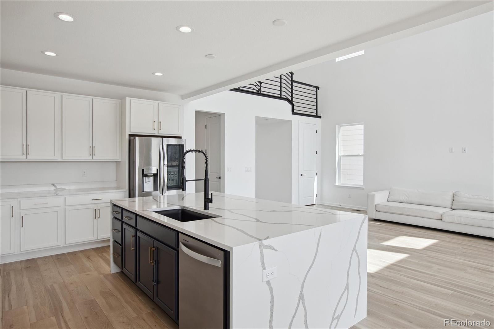 741 Simmental Loop Castle Rock, CO 80104 - Photo 11 of 50 a kitchen with kitchen island a sink stove and refrigerator