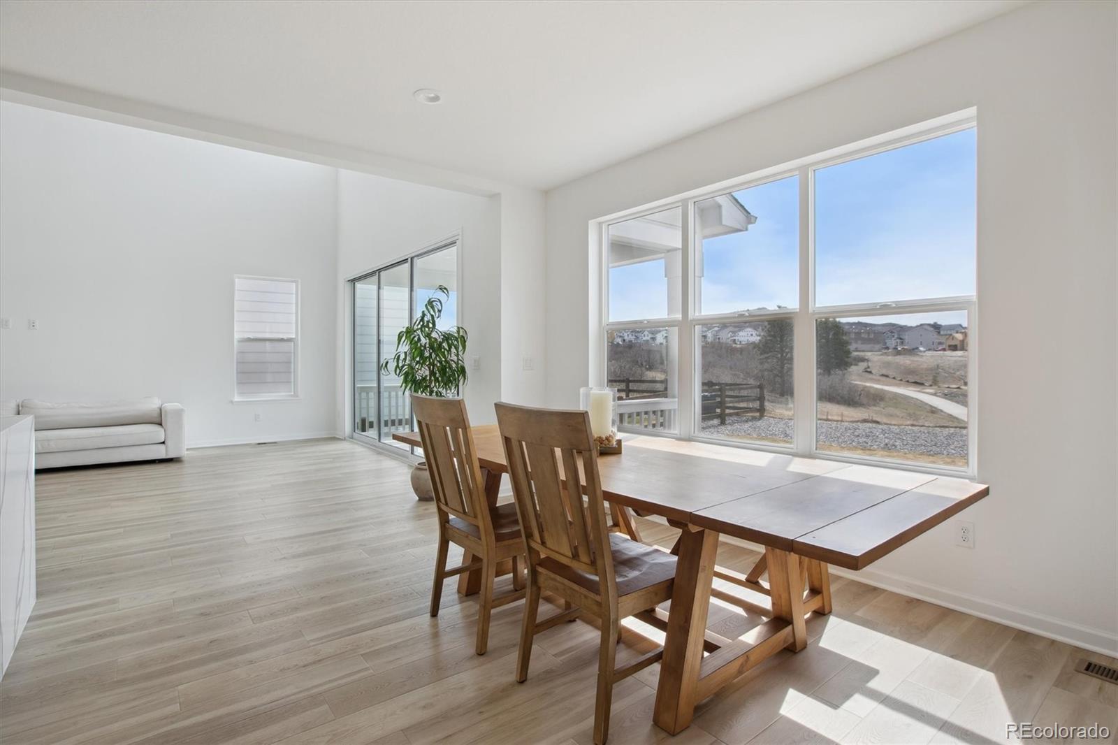 741 Simmental Loop Castle Rock, CO 80104 - Photo 15 of 50 a view of a dining room with furniture and wooden floor