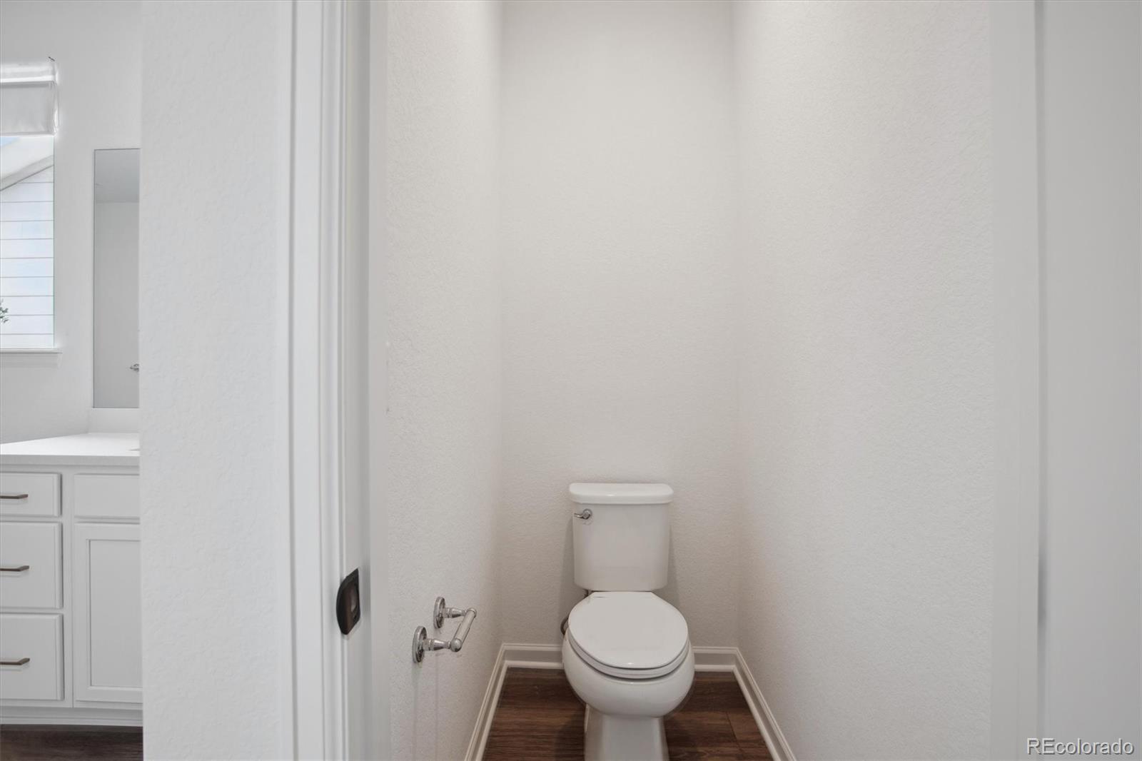 741 Simmental Loop Castle Rock, CO 80104 - Photo 29 of 50 a white toilet sitting next to a shower