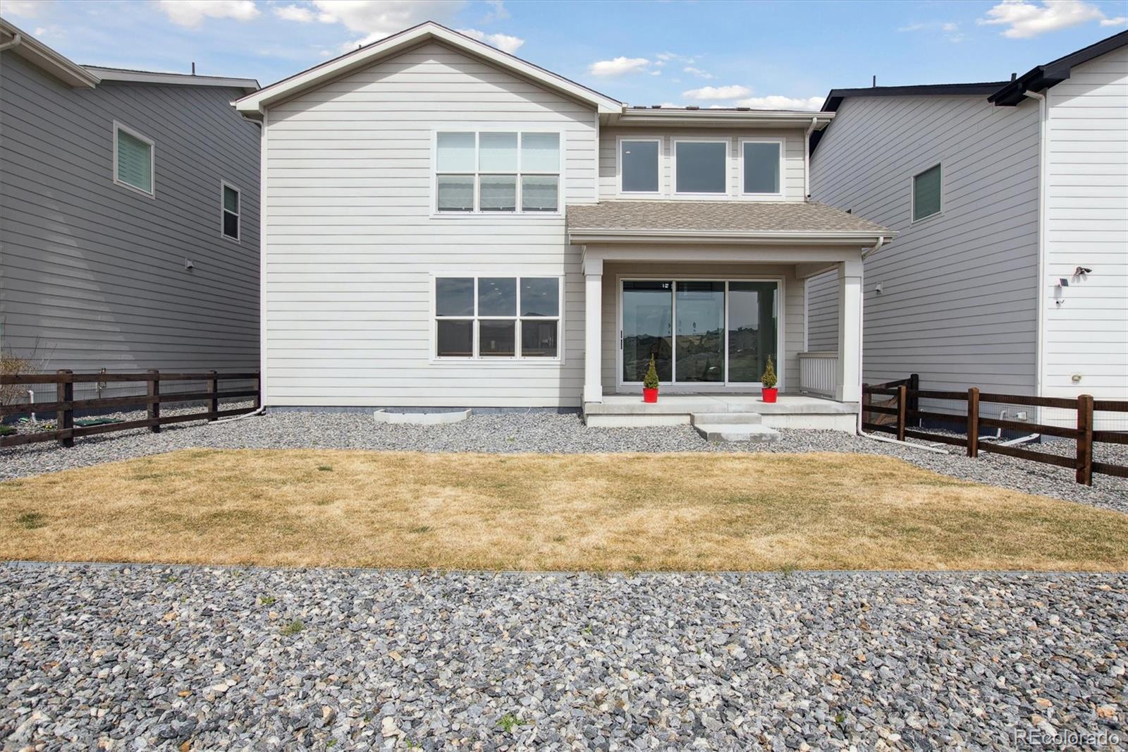 741 Simmental Loop Castle Rock, CO 80104 - Photo 41 of 50 a view of a white house with swimming pool in front of it