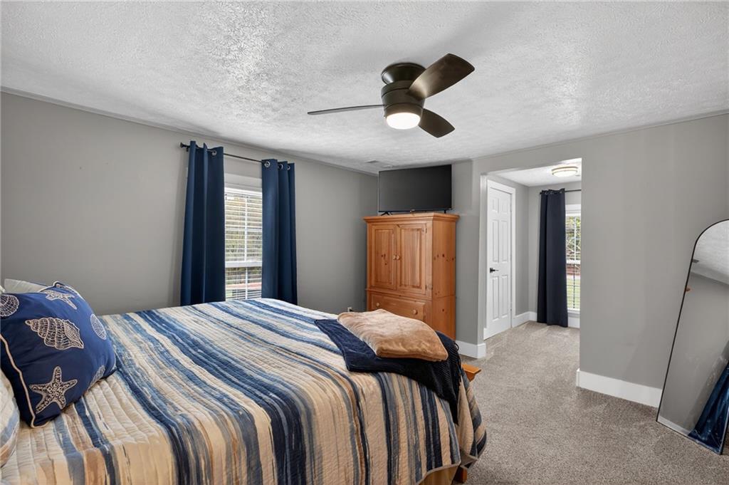 3590 Roosterville Road Roopville, GA 30170 - Photo 49 of 66 a bedroom with a bed and a chandelier