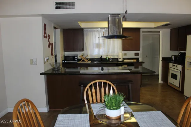 a kitchen with a table and chairs in it
