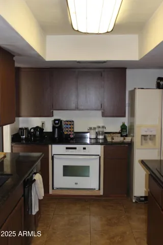 a kitchen with a stove a sink and a refrigerator