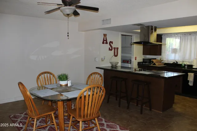 a view of a dining room with a table and chairs