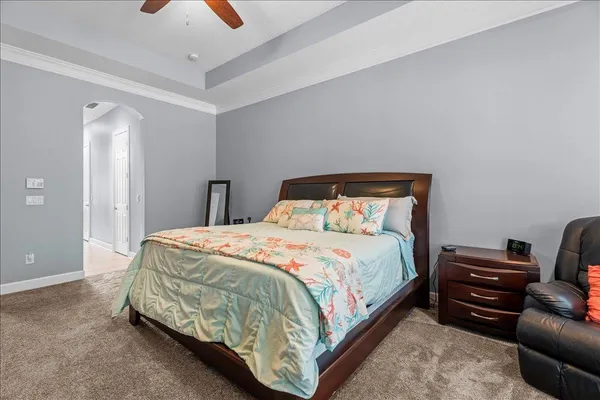 a spacious bathroom with a sink a bathtub a mirror a vanity a lamp and window