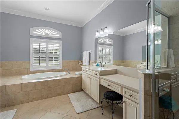 a bathroom with a sink shower and a mirror