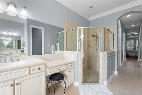 a en suite bathroom with a double vanity sink and a mirror