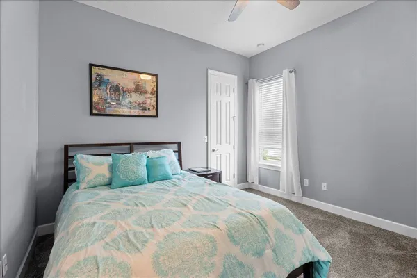 a bathroom with a sink a toilet a mirror and shower