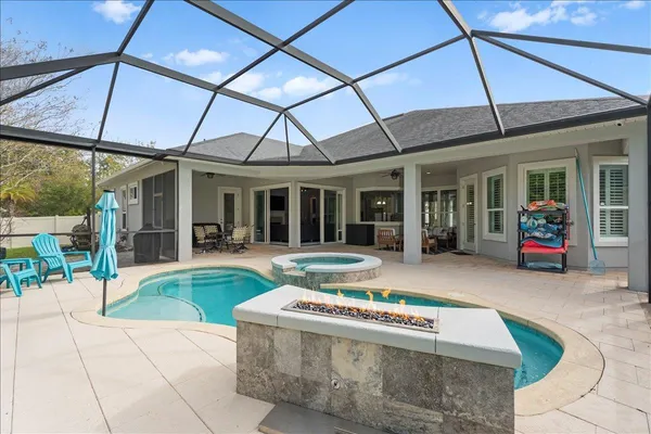 a view of a house with a yard and sitting area