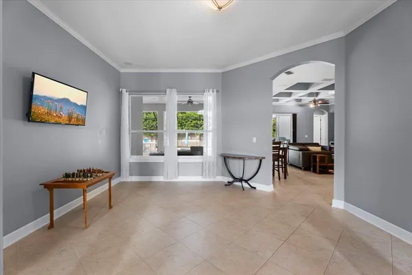 a view of a dining room with furniture and chandelier