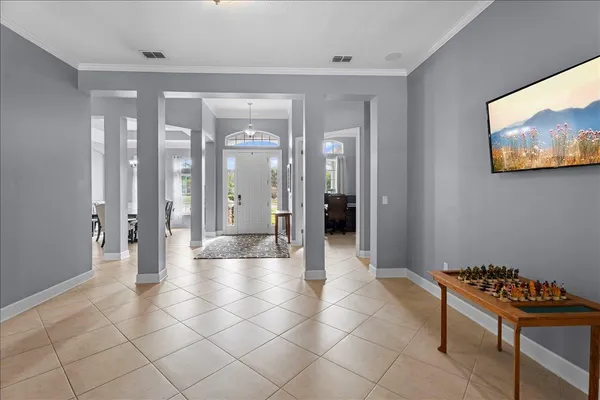 a view of a dining room with furniture and chandelier
