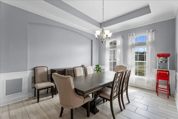 a kitchen with stainless steel appliances granite countertop a refrigerator sink stove and white cabinets
