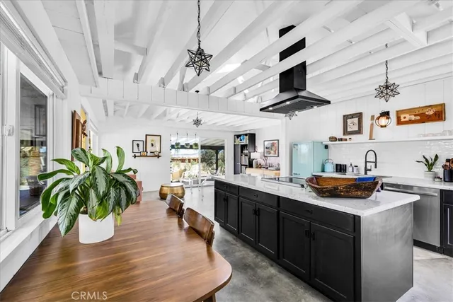 a kitchen with stainless steel appliances granite countertop a sink a stove and cabinets