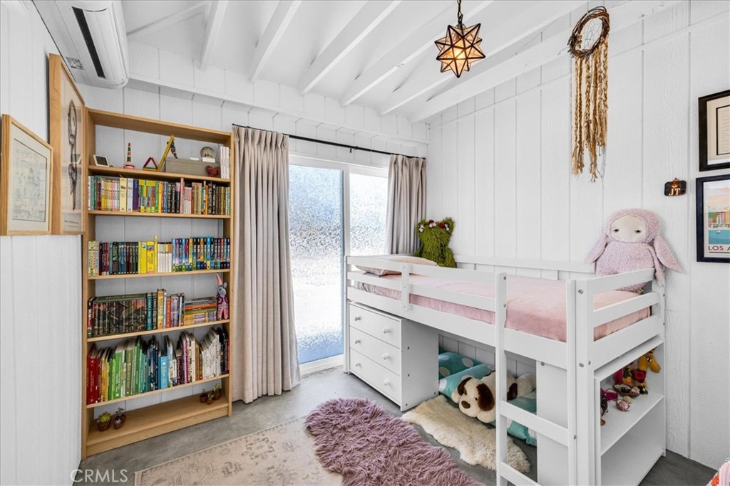 2837 Border Avenue Joshua Tree, CA 92252 - Photo 20 of 52 a bedroom with furniture and a book shelf