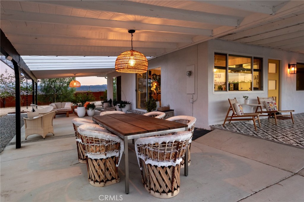 2837 Border Avenue Joshua Tree, CA 92252 - Photo 25 of 52 a table and chairs in a room with a large window