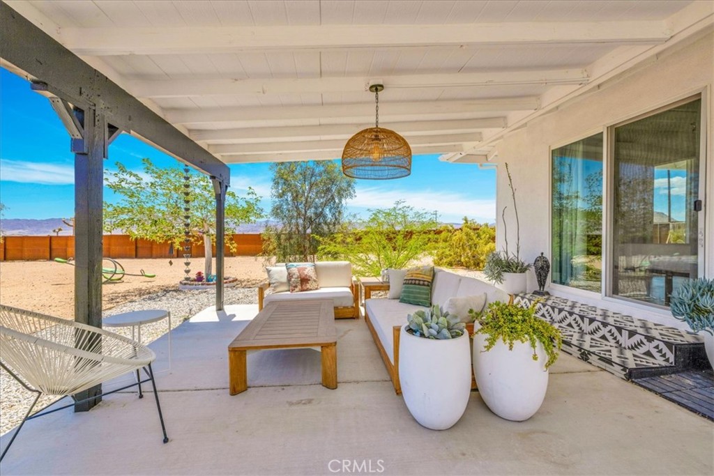 2837 Border Avenue Joshua Tree, CA 92252 - Photo 28 of 52 a room with furniture and a floor to ceiling window