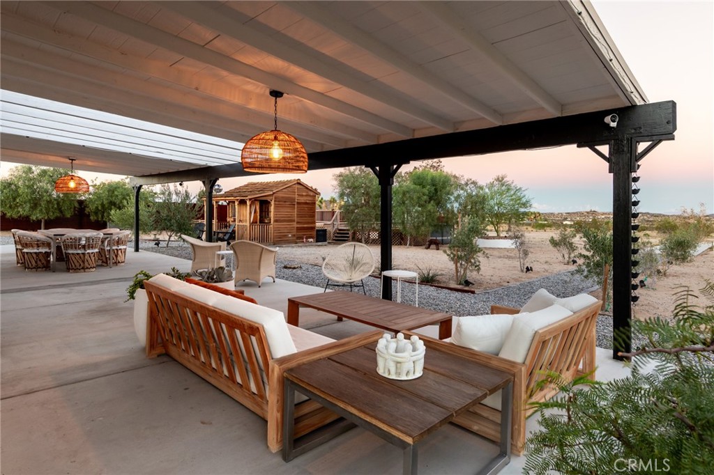 2837 Border Avenue Joshua Tree, CA 92252 - Photo 30 of 52 a living room with patio furniture and a floor to ceiling window