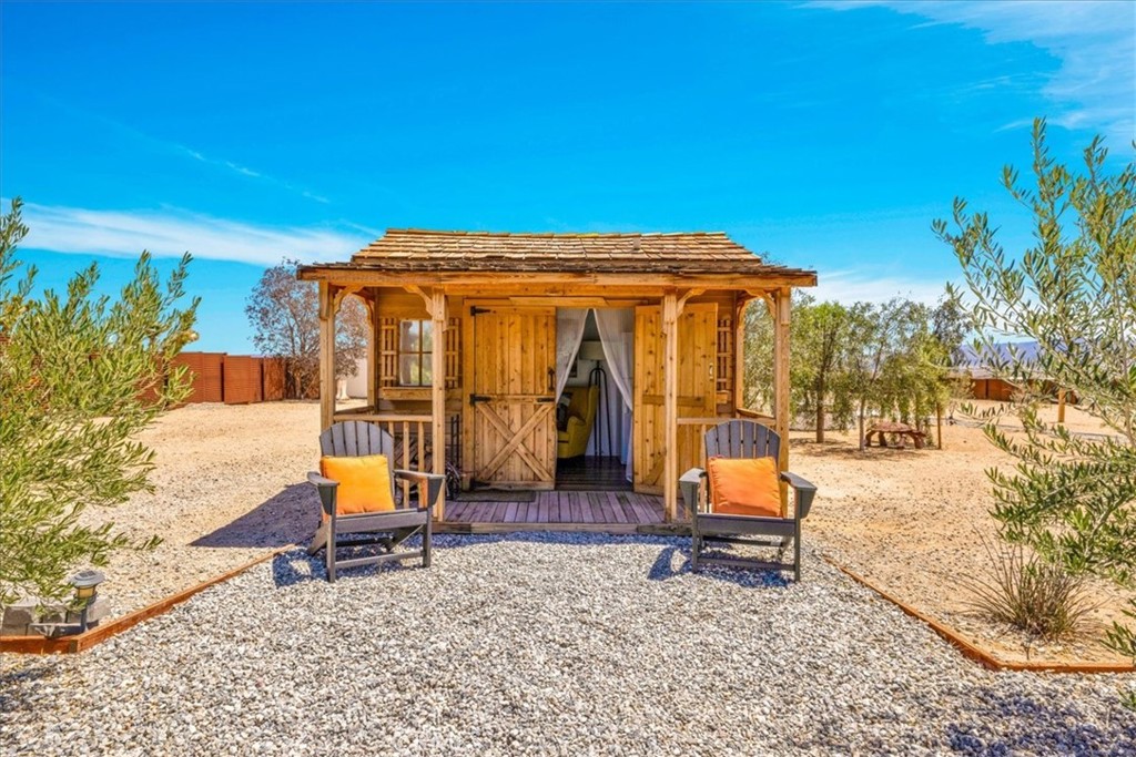2837 Border Avenue Joshua Tree, CA 92252 - Photo 32 of 52 a blue bench sitting in front of a house