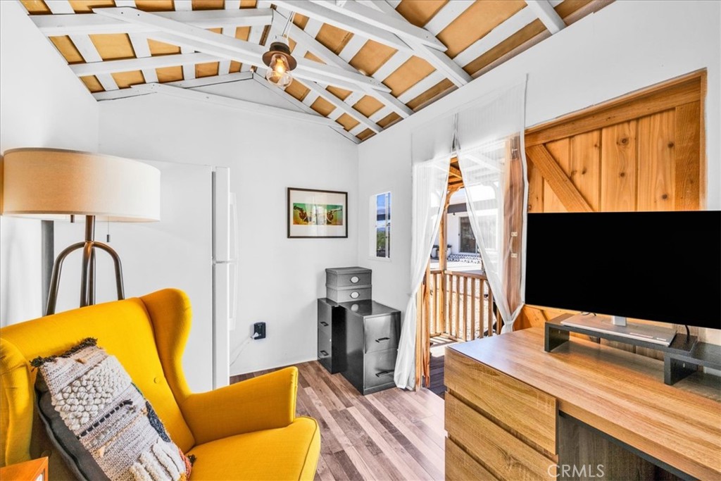 2837 Border Avenue Joshua Tree, CA 92252 - Photo 34 of 52 a bedroom with furniture and a flat screen tv