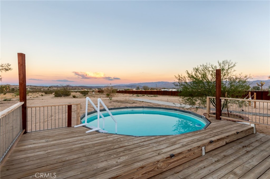 2837 Border Avenue Joshua Tree, CA 92252 - Photo 44 of 52 a view of a swimming pool with a lounge chair
