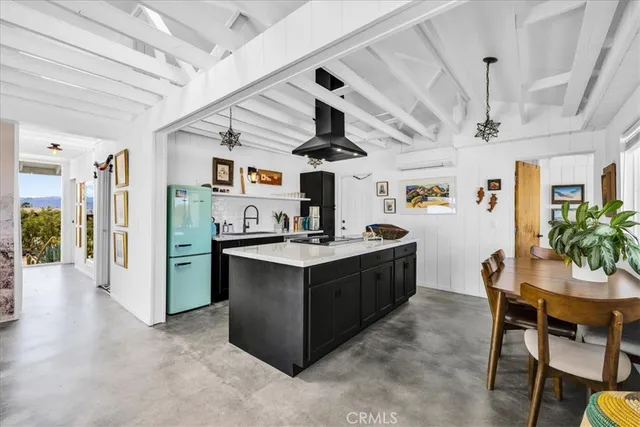 a kitchen with stainless steel appliances granite countertop a sink and a refrigerator