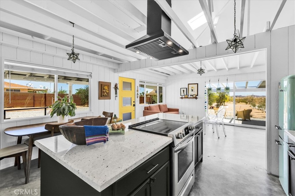 2837 Border Avenue Joshua Tree, CA 92252 - Photo 10 of 52 a kitchen with a stove and a refrigerator