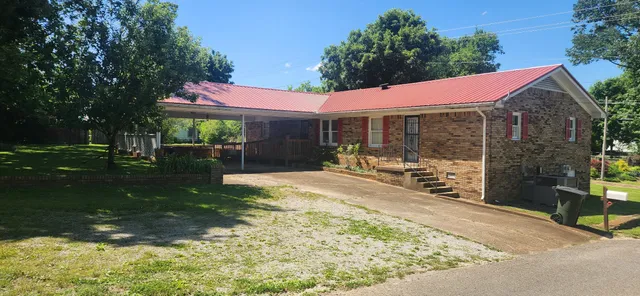 a view of a house with backyard porch and sitting area