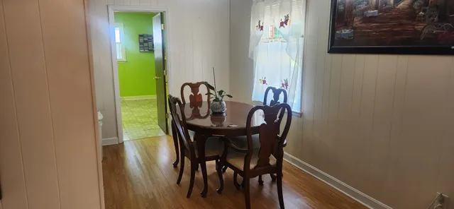 a view of a dining room with furniture and wooden floor
