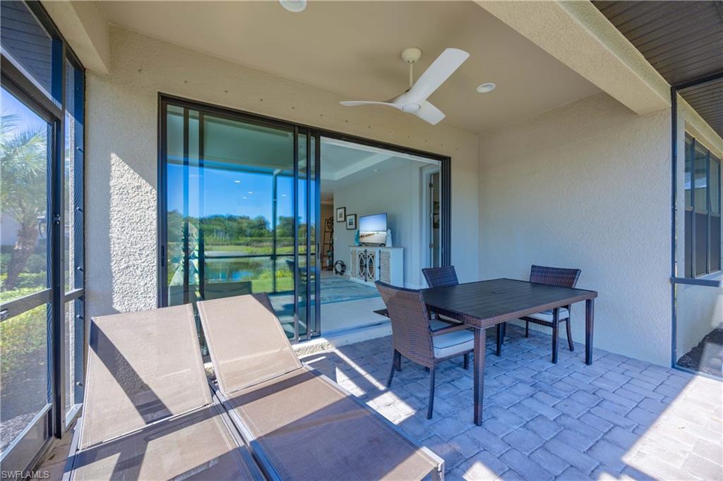 8110 Calle Canovas Street, Unit A Naples, FL 34114 - Photo 13 of 41 a living room with furniture and a floor to ceiling window