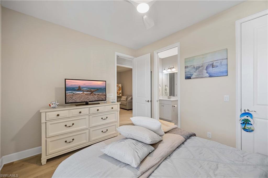 8110 Calle Canovas Street, Unit A Naples, FL 34114 - Photo 23 of 41 a living room with furniture and a flat screen tv