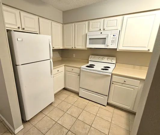 a kitchen with cabinets appliances and a sink
