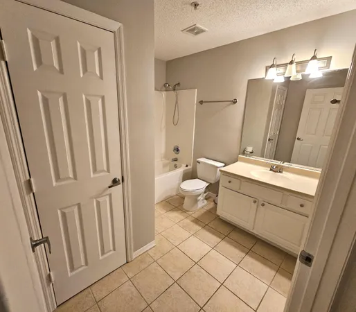 a bath room with a sink a toilet and a mirror