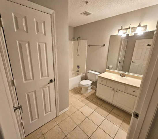a bath room with a sink a toilet and a mirror