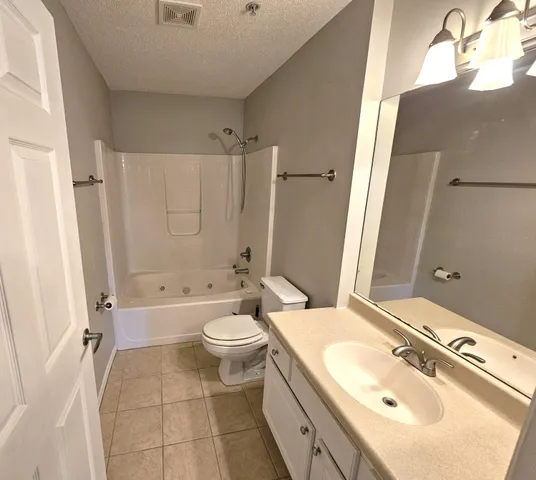 a white toilet sitting next to a bathroom sink