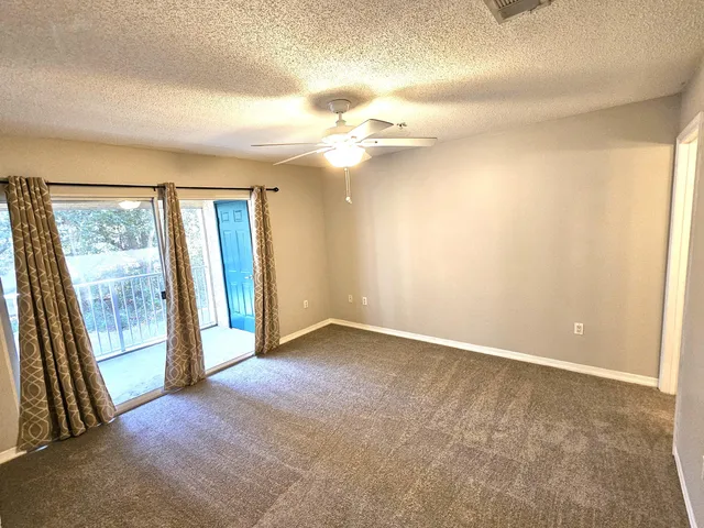 an empty room with windows and entrance