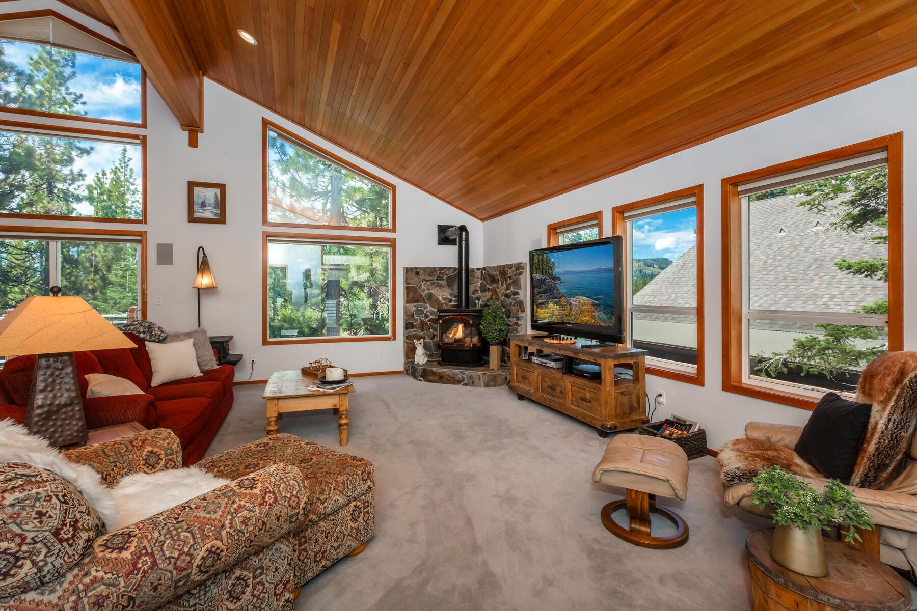 13213 Roundhill Drive Truckee, CA 96161 - Photo 4 of 21 a living room with furniture a flat screen tv and a large window