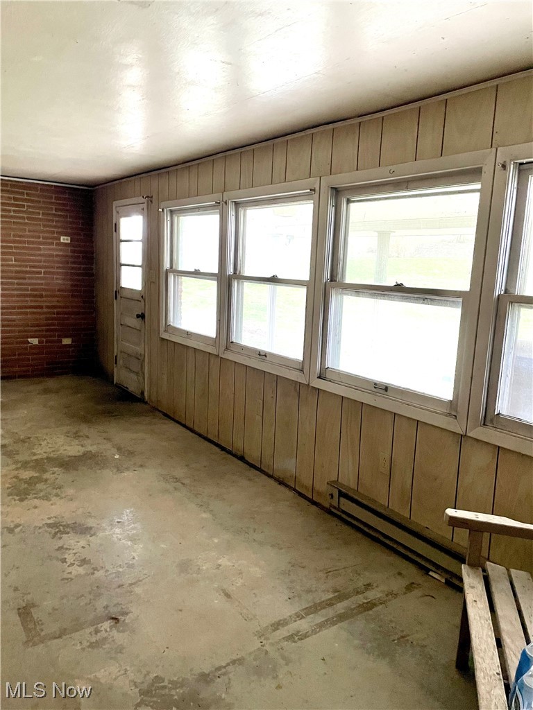 9810 Ziegler Road Hanoverton, OH 44423 - Photo 13 of 18 Unfurnished room featuring unfinished concrete floors and wood walls