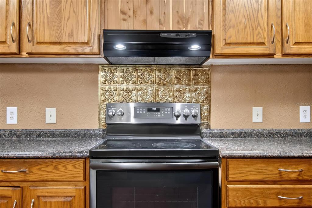 156 Kingfish Road Pomona Park, FL 32181 - Photo 30 of 55 a stove top oven sitting inside of a kitchen